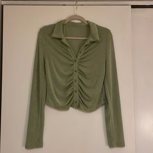 Green button down. Stretchy material. Somewhat cropped.